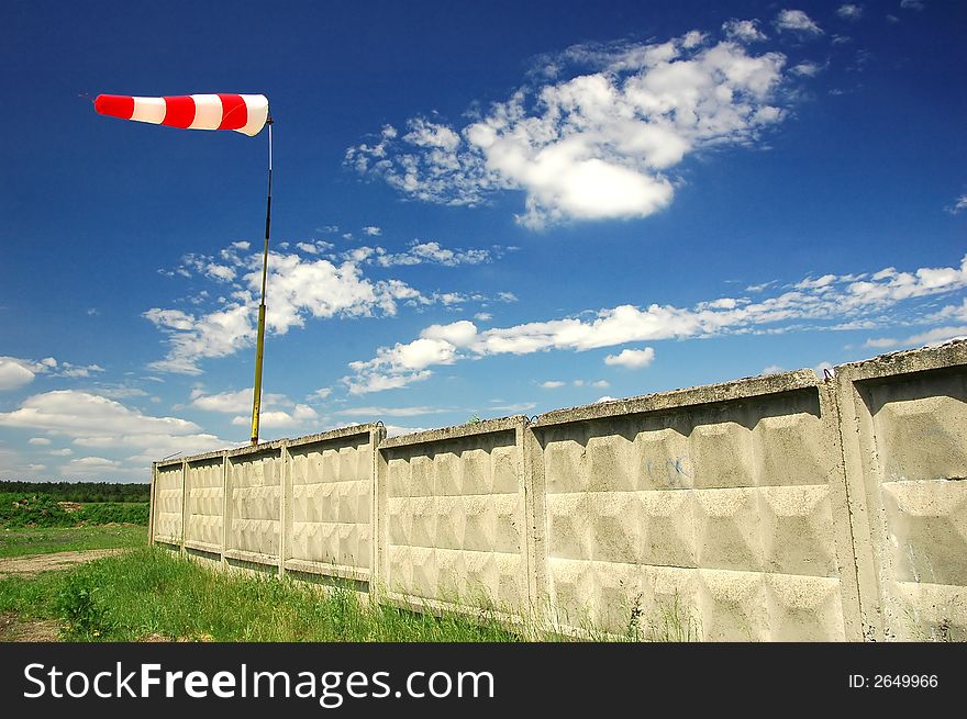 Red and white windsock with wall