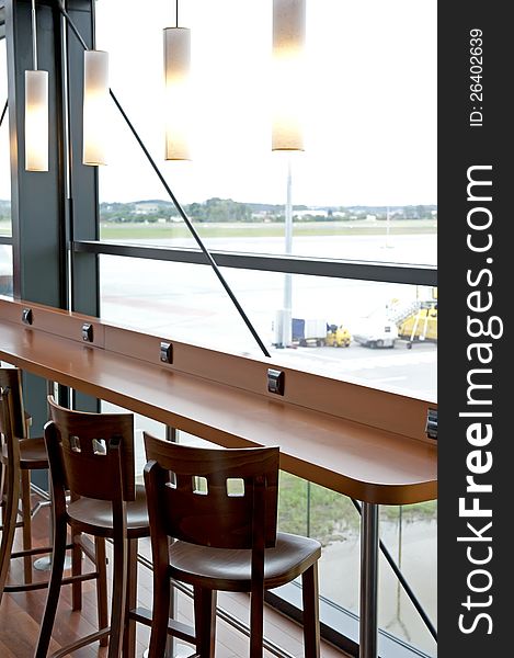 Details of the counter and empty chairs in simple modern bar. Details of the counter and empty chairs in simple modern bar.