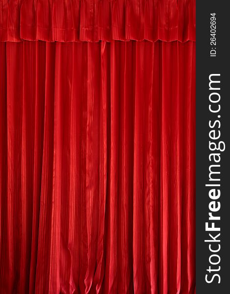 Vertical a red curtain texture is decoration background. Vertical a red curtain texture is decoration background