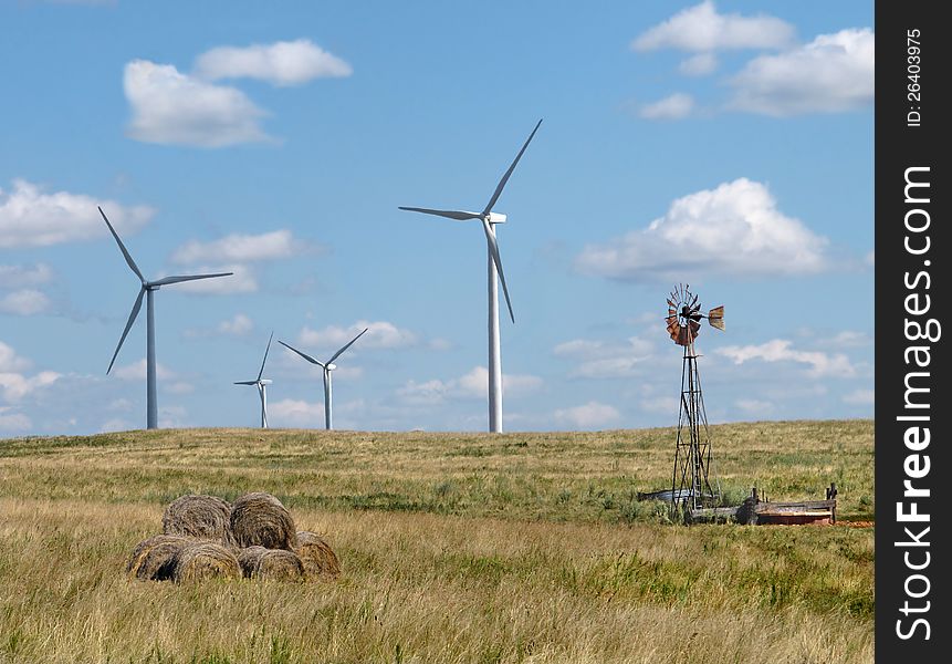 Old And New Windmills In A Rural Pasture