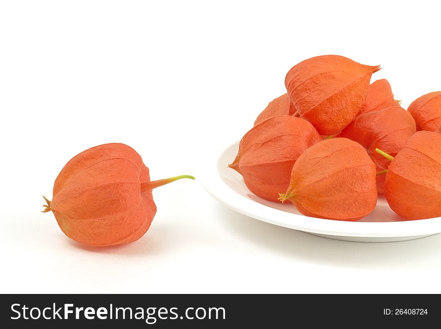 Fine colored fruits on plate on white background. Fine colored fruits on plate on white background