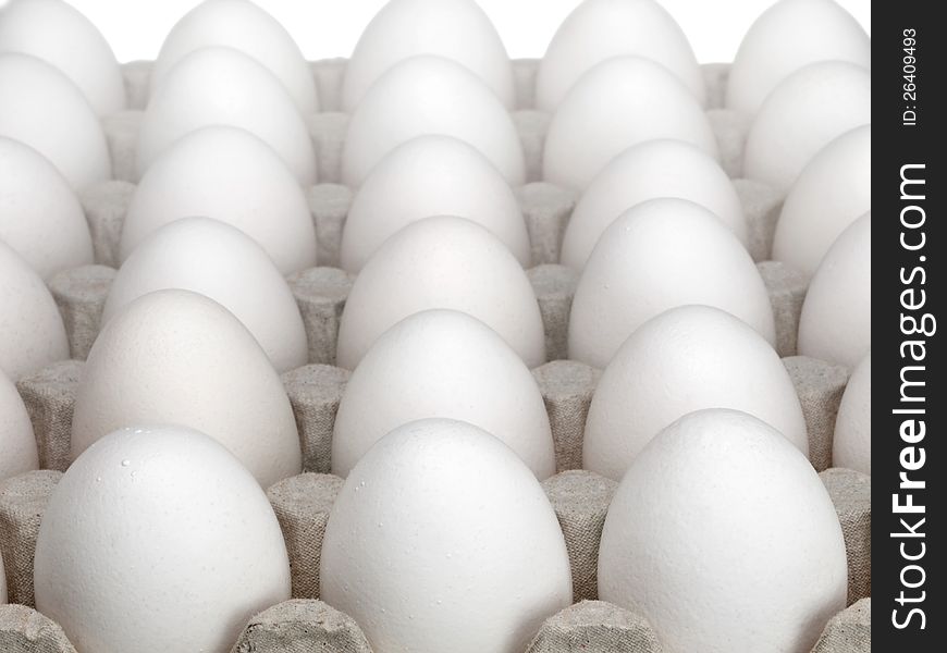 White eggs of a hen in harmless, cardboard packing on a white background. White eggs of a hen in harmless, cardboard packing on a white background.