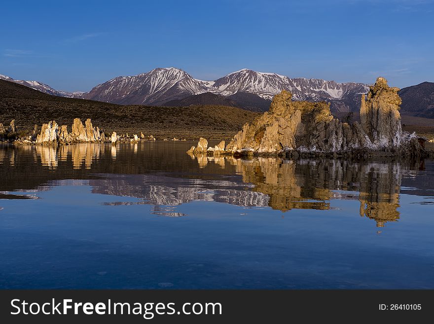 The tuffa salt formations at lake mono, east california with the sierra navada mountain range lit up in morning sun. The tuffa salt formations at lake mono, east california with the sierra navada mountain range lit up in morning sun