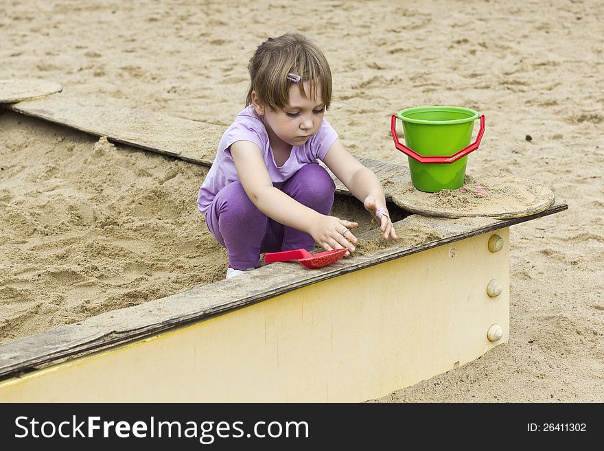 Sweet little girl playing in the sandbox. Sweet little girl playing in the sandbox