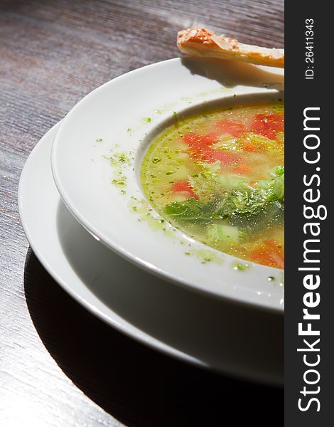 Soup in a plate on the table. macro