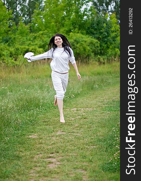 Happy woman running on the path