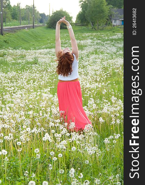 Beautiful girl standing on the field on nature