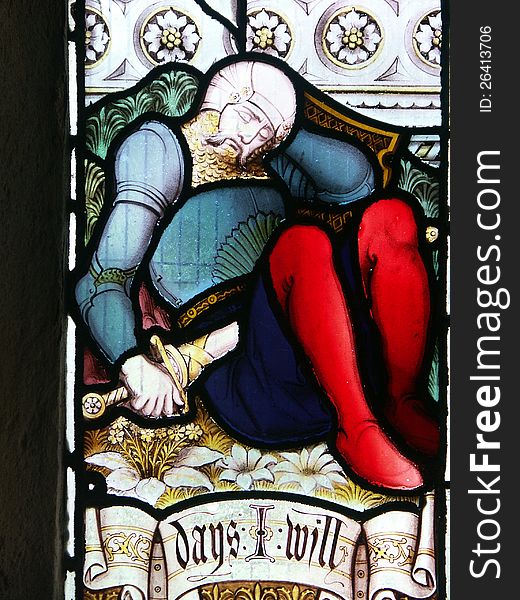 Section of stained glass window showing sleeping armoured soldier. Section of stained glass window showing sleeping armoured soldier