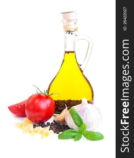 A bottle of olive oil with garlic, tomatoes and peppers. A bottle of olive oil with garlic, tomatoes and peppers.