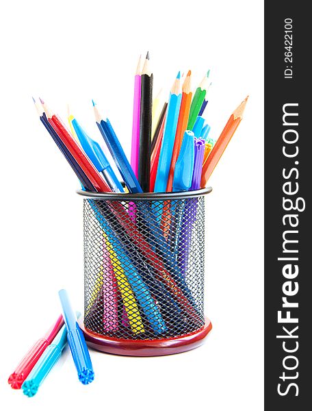 Color pencils and pens in metal vase on a white background