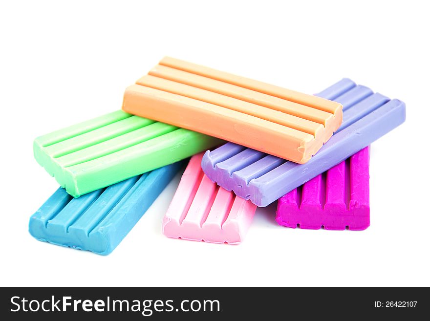 Colored modeling  clay  on a white background. Colored modeling  clay  on a white background