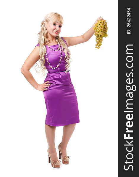 Young girl in a purple evening dress with a bunch of grapes. Isolate on white.