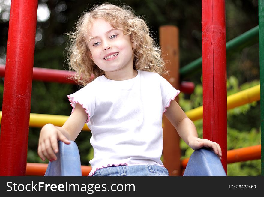Young girl playing on the slide. Young girl playing on the slide
