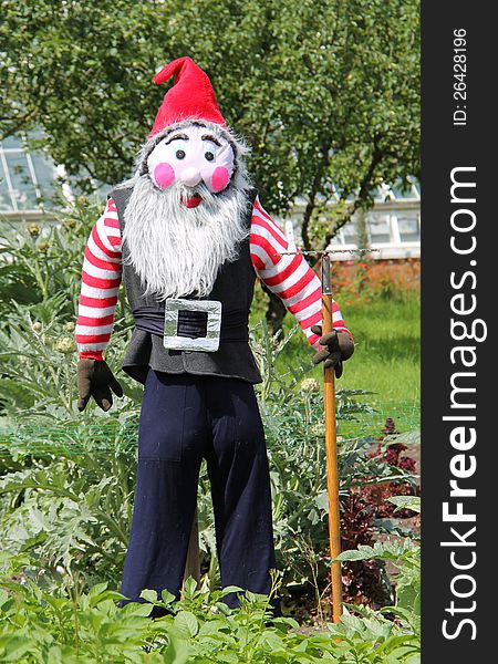 A Scarecrow Dressed as a Gardening Gnome. A Scarecrow Dressed as a Gardening Gnome.