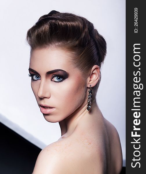 Portrait of beautiful fashionable woman with earrings - stylish styling coiffure (hairstyle). Portrait of beautiful fashionable woman with earrings - stylish styling coiffure (hairstyle)