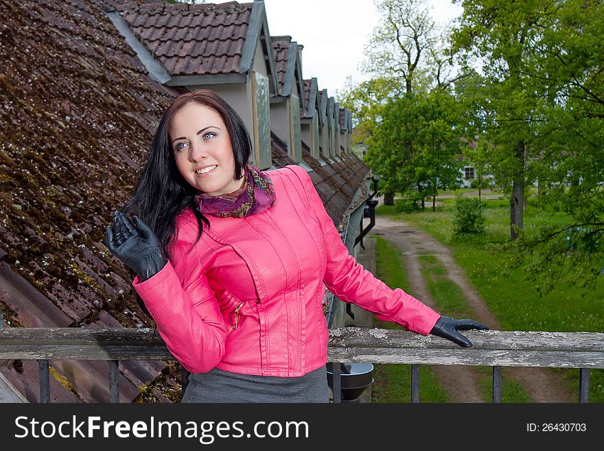 A Girl Standing On The Balcony