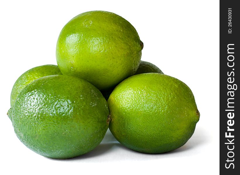 A group of limes arranged in a pyramid formation and isolated on a white background. A group of limes arranged in a pyramid formation and isolated on a white background