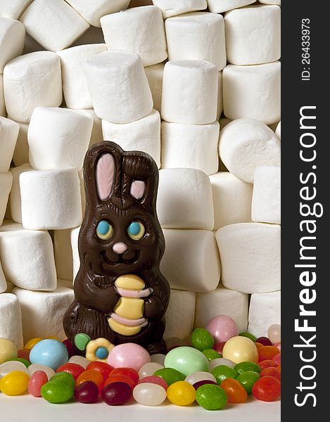 Horizontal of chocolate rabbit easter candy and background of marshmallows