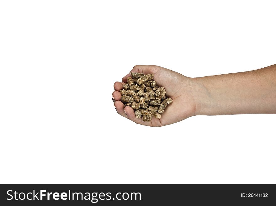 Hand with natural wood pellet on a white background. Hand with natural wood pellet on a white background.
