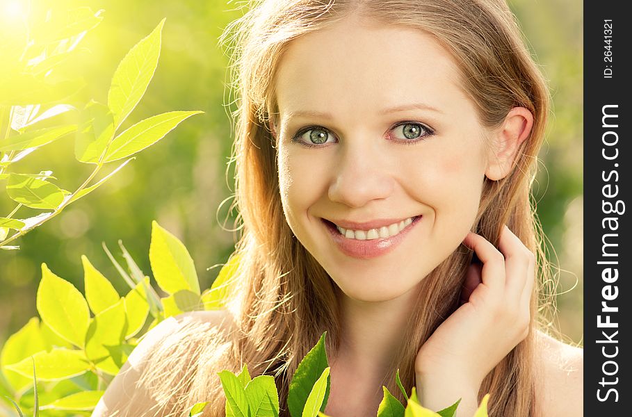 Beauty girl in nature with green leaves