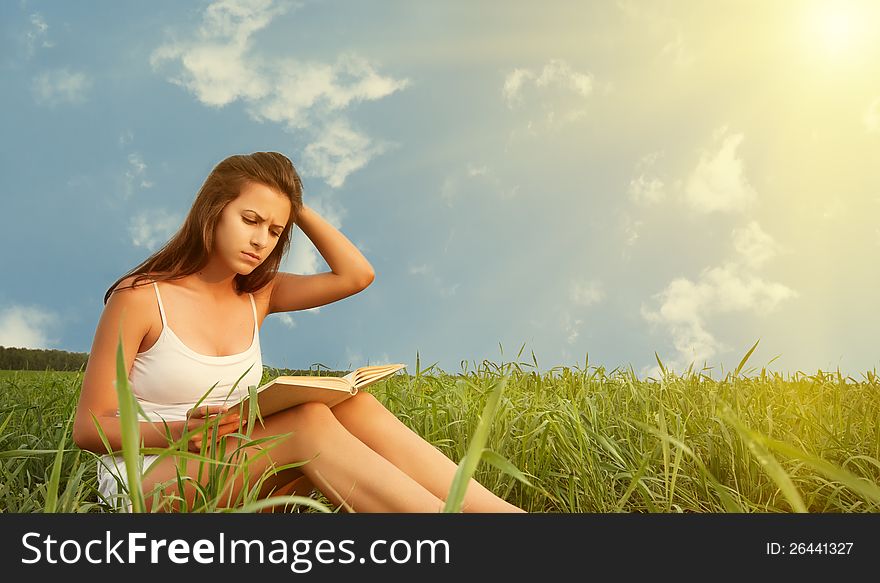 Girl Reading A Book On Nature