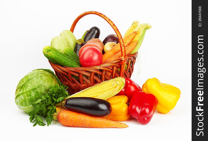 Basket with vegetables on white