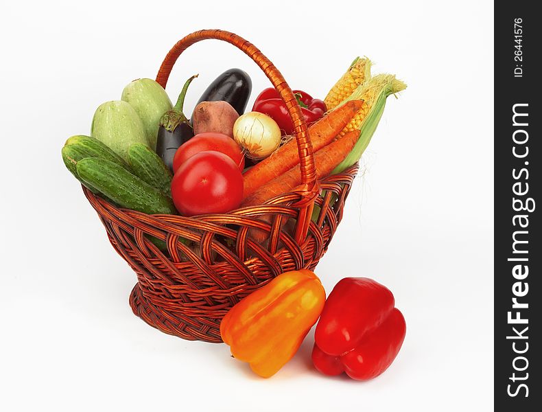 Basket with vegetables on white