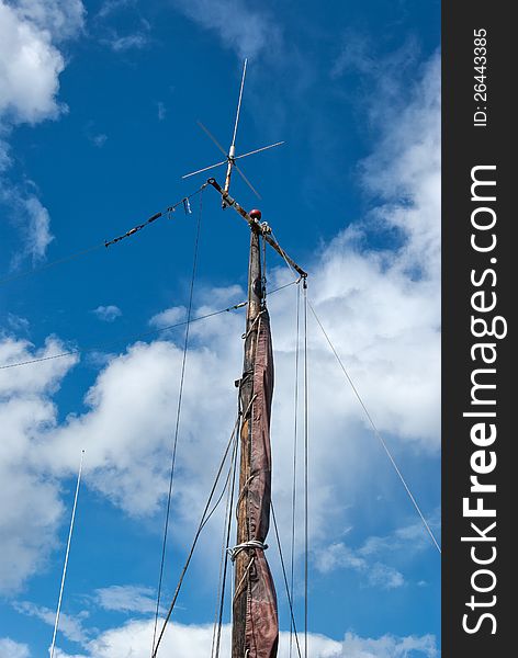 Foresail, Jib, and Wooden Mast of a sailing yacht vertical perspective boating background