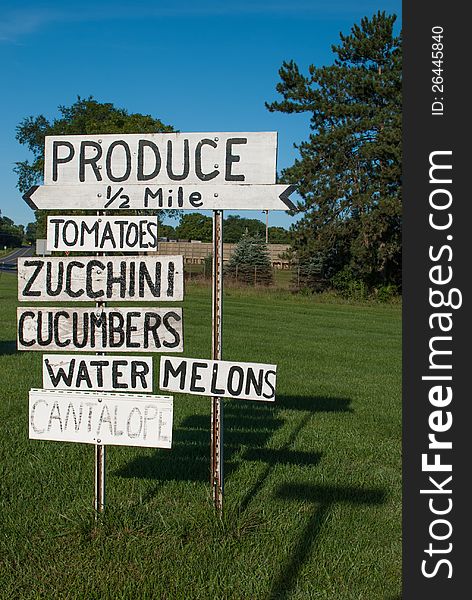 Farmer's hand-painted roadside produce sign.