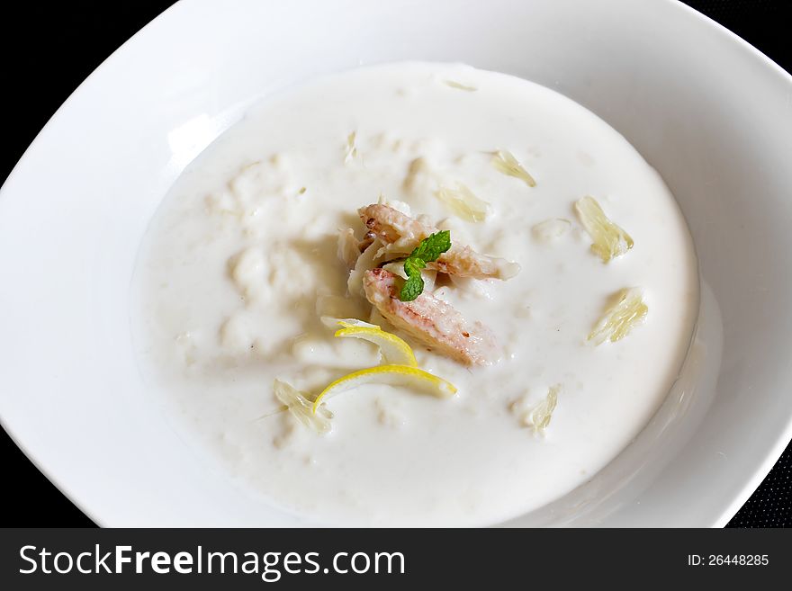 Fresh nutrition crab soup in the white plate.