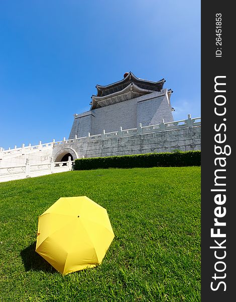 Yellow Umbrella On Green Grass With Blue Sky