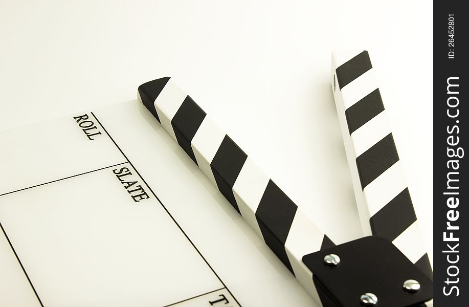 Film clapboard with black stripes on white background