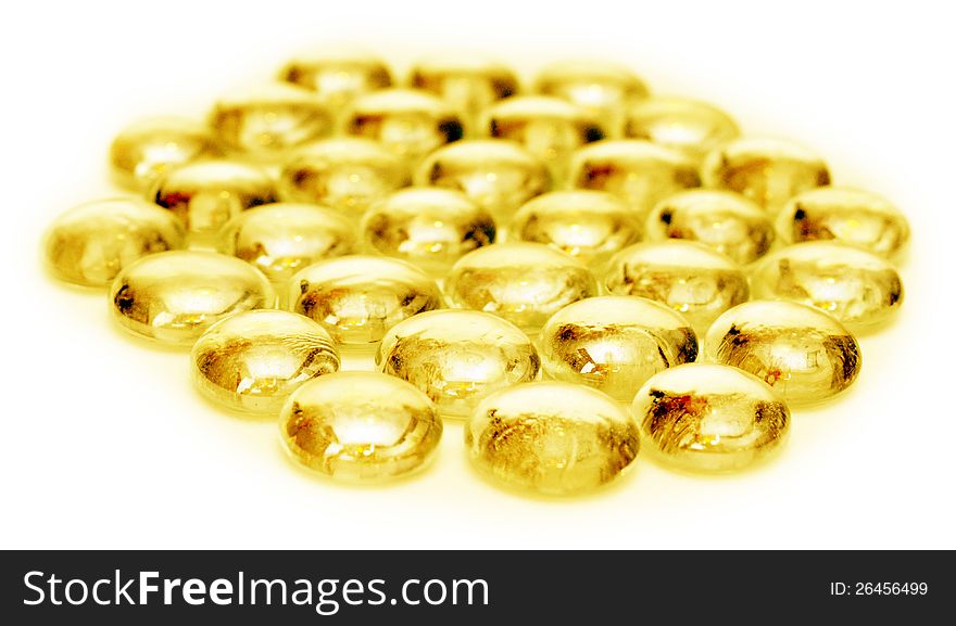 Small golden stones over white background. Small golden stones over white background