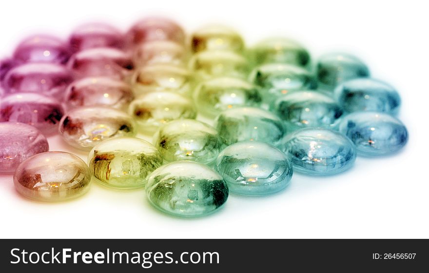 Small colored stones over white background. Small colored stones over white background