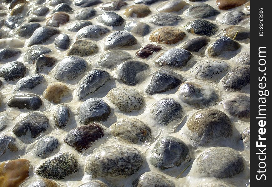 Wet stones pavement forming a texture. Wet stones pavement forming a texture