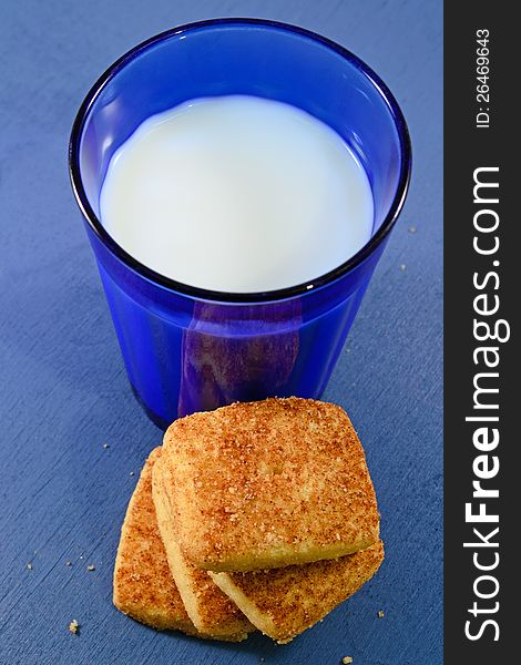 A glass of milk and cinnamon cookies. A glass of milk and cinnamon cookies
