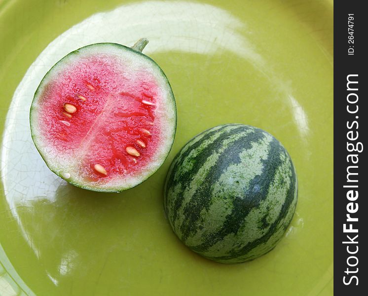 Homegrown little ripe watermelon cut in two. Homegrown little ripe watermelon cut in two
