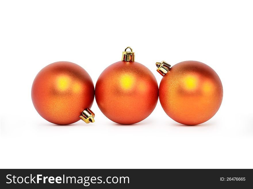 Few Christmas balls lying on white background in a row. Clipping path is included