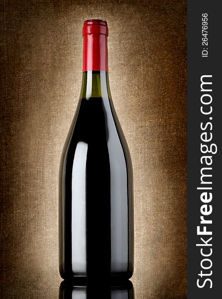 Wine bottle on a background of old canvas. Wine bottle on a background of old canvas