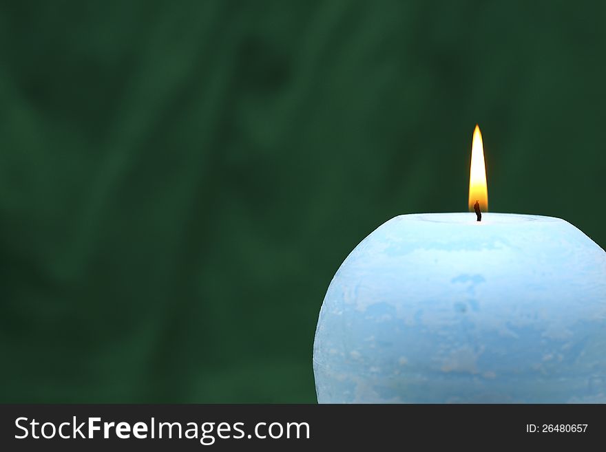 The blue candle, green background