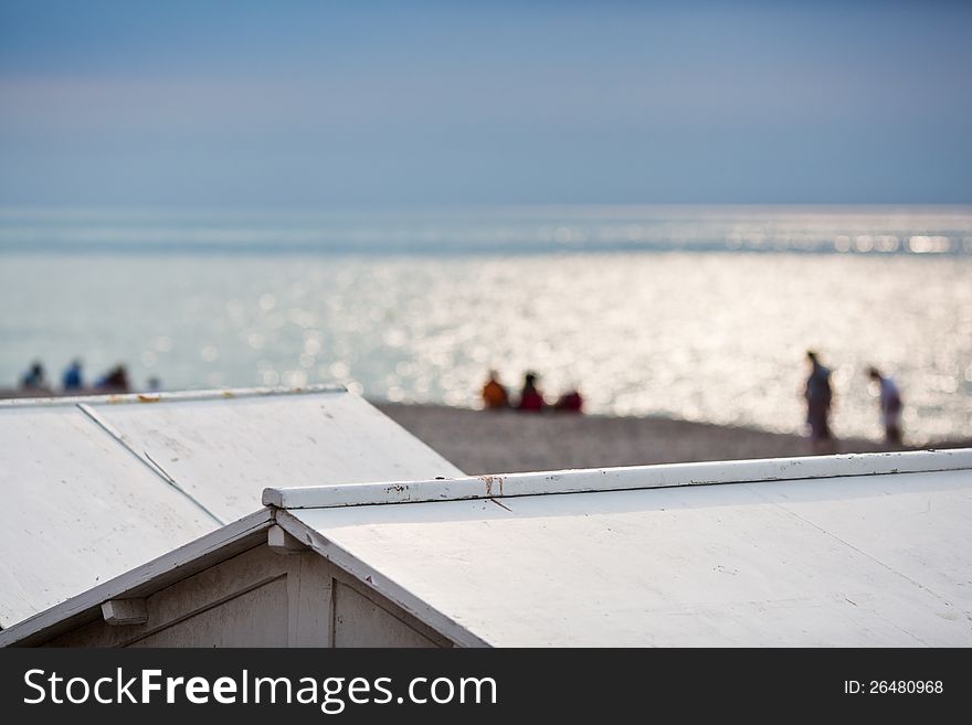 View over beach hut roofs to the beach