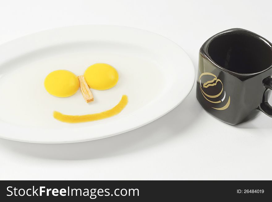 Images 2 pieces large egg yolk derived from a single egg. its shape resembles a smile faces and there's a ceramic glass beside her. Images 2 pieces large egg yolk derived from a single egg. its shape resembles a smile faces and there's a ceramic glass beside her.