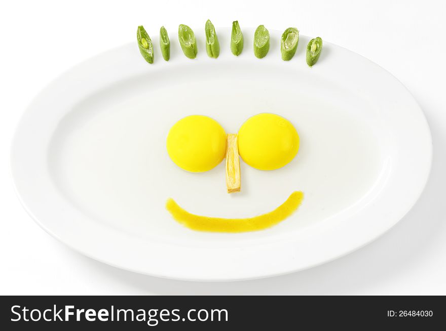 Images 2 pieces large egg yolk derived from a single egg. its shape resembles a smile and facial hair of vegetable beans. Images 2 pieces large egg yolk derived from a single egg. its shape resembles a smile and facial hair of vegetable beans.