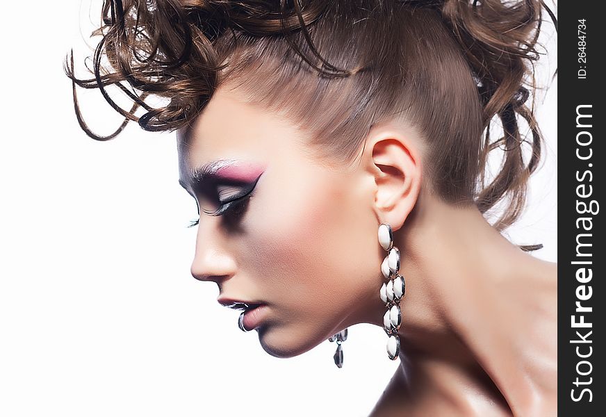 Fashion woman - bright unusual hairstyle, earrings and vibrant stylish make-up. Fashion woman - bright unusual hairstyle, earrings and vibrant stylish make-up