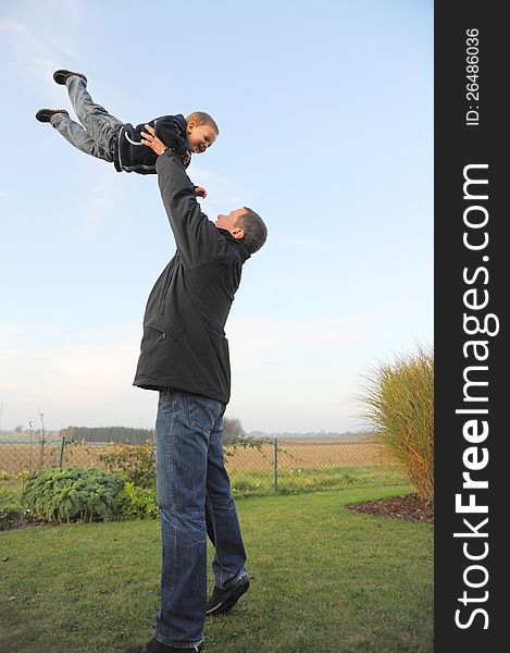 Father and son having fun outside in the garden. Father and son having fun outside in the garden