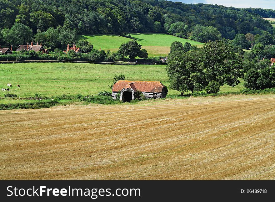 An English Rural Landscape with field of golden wheat stubble. An English Rural Landscape with field of golden wheat stubble