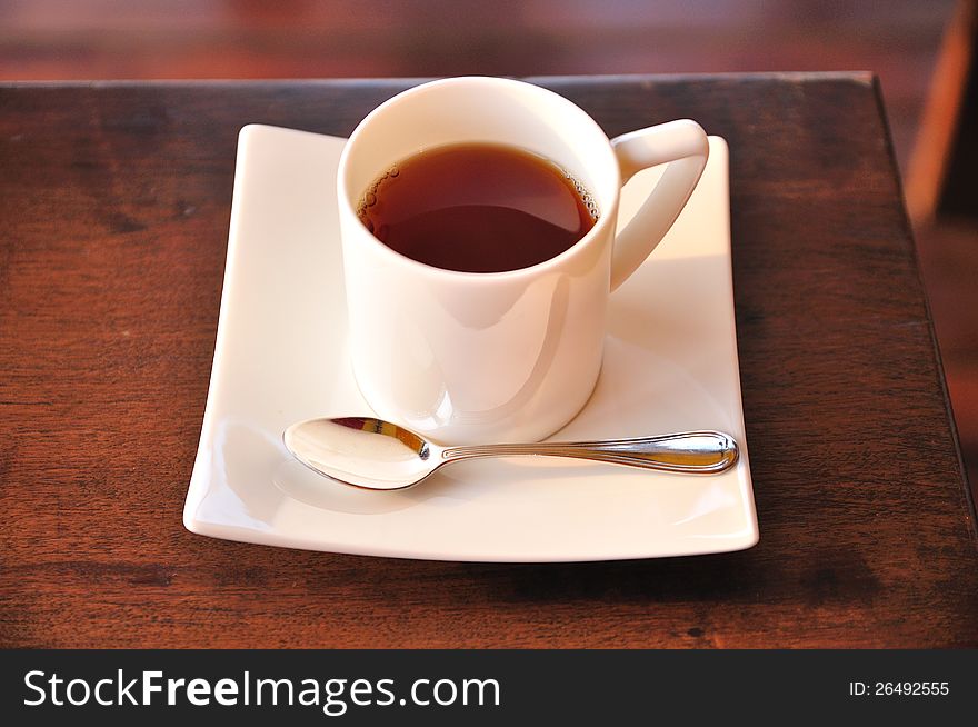 A cup of hot tea on table
