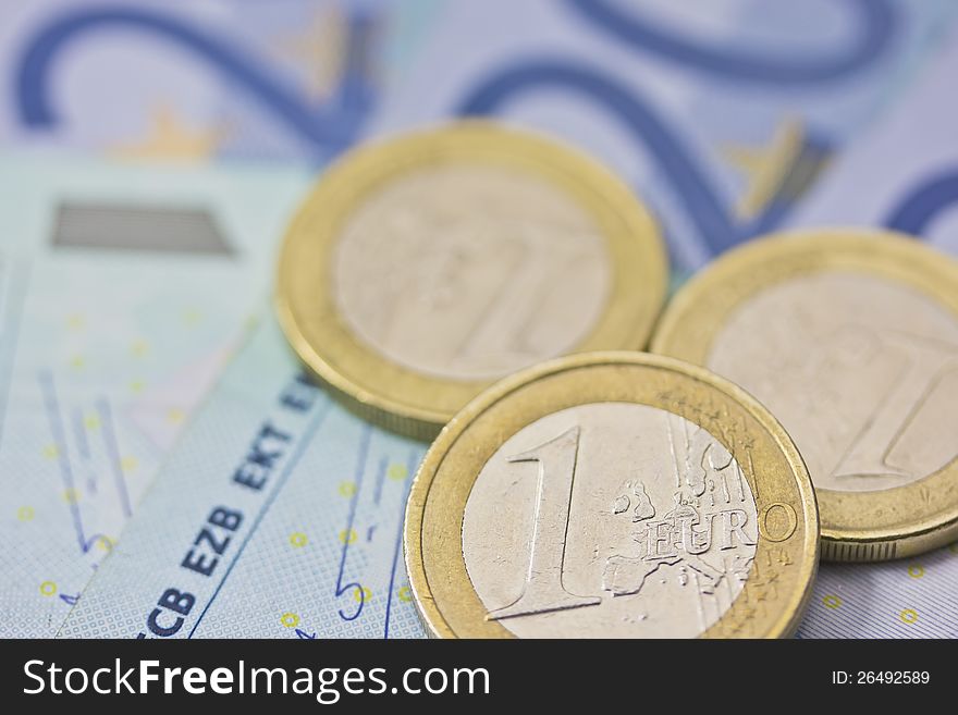 Detailed view of euro coins lying on paper money. Background. Detailed view of euro coins lying on paper money. Background.