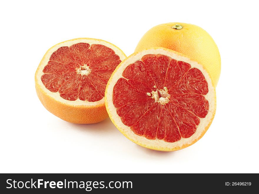 Grapefruit and two halves on white background