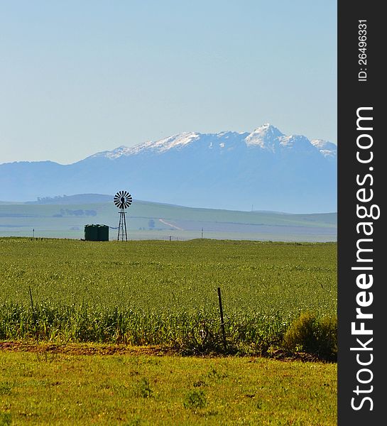 Landscape with windmill water pump and ceres mountains with snow